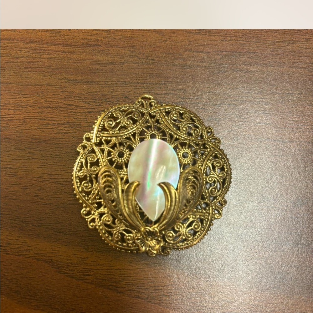 Elegant Gold Filigree Brooch with Iridescent Center